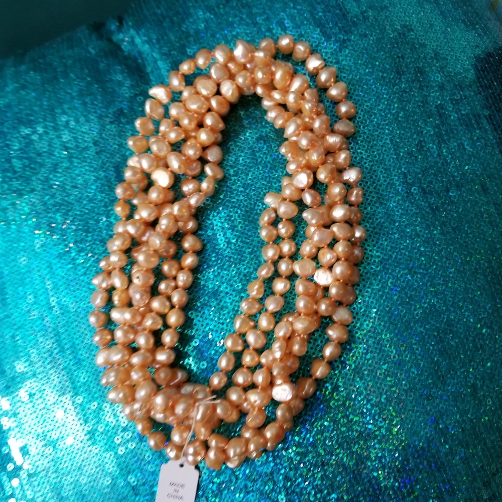 Peach or light coral colored super long pearl necklace